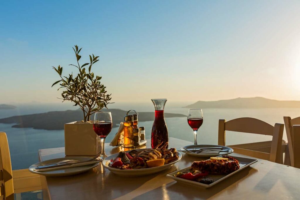 santorini sunlight wine dinner outdoors sea