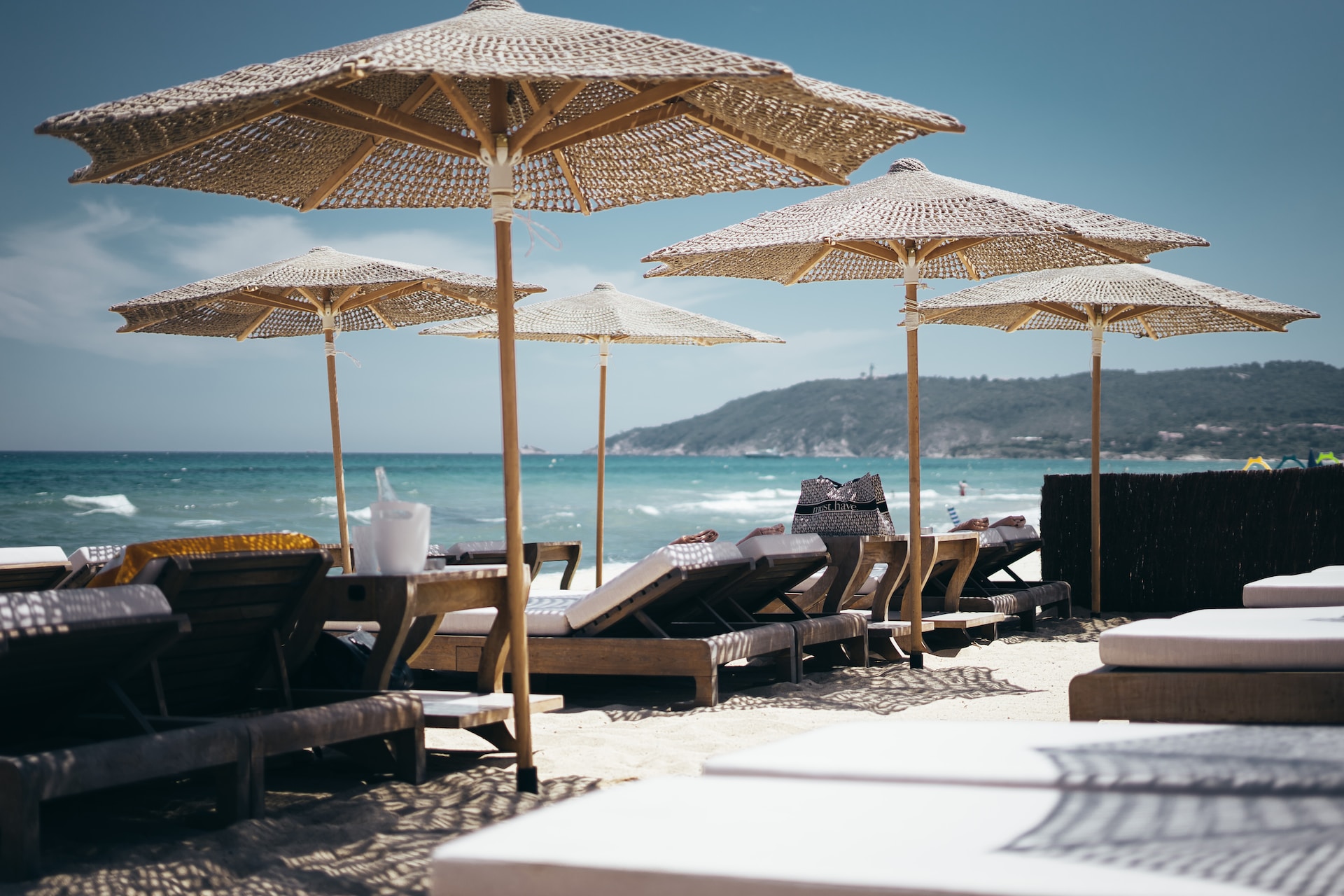 Umbrellas and lounge chairs on white sand beach
